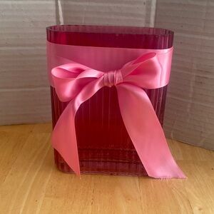 Oval shaped pink glass vase about 6.5 x 5 x 1.5 in. Use alone or for flowers.